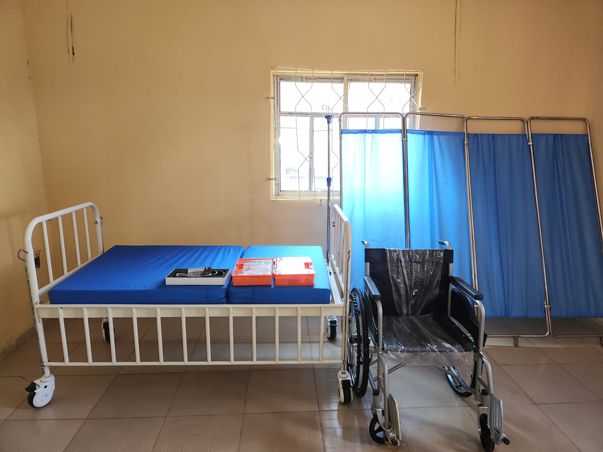 A care and medical room at Kerimat Foundation with beds, supplies and a wheelchair